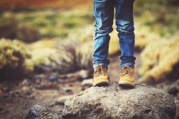 Travel,Concept,-,Little,Boy,Hiking,Boots,In,Mountains